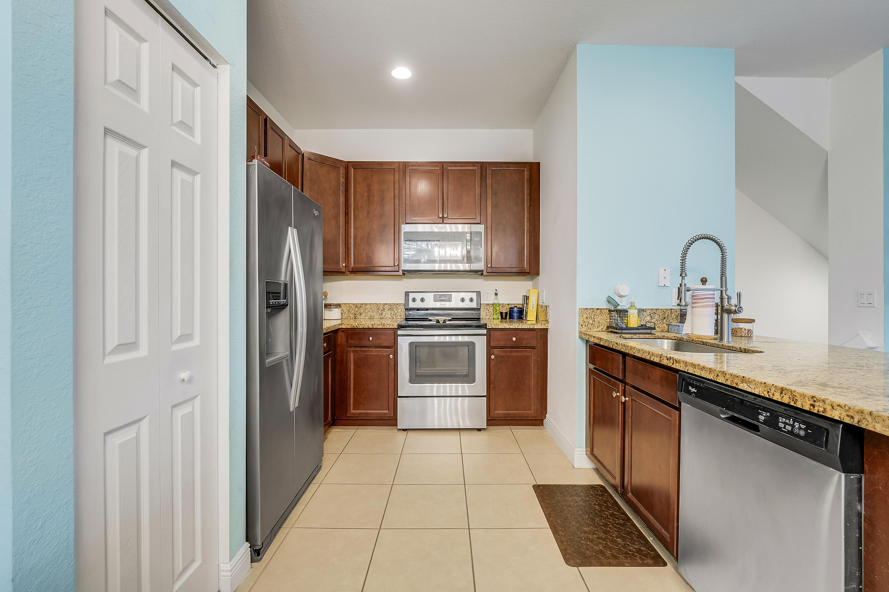2900 Southwest 119th Way Miramar, FL 33025 - Photo 25 of 37 a kitchen with stainless steel appliances granite countertop a refrigerator and a sink