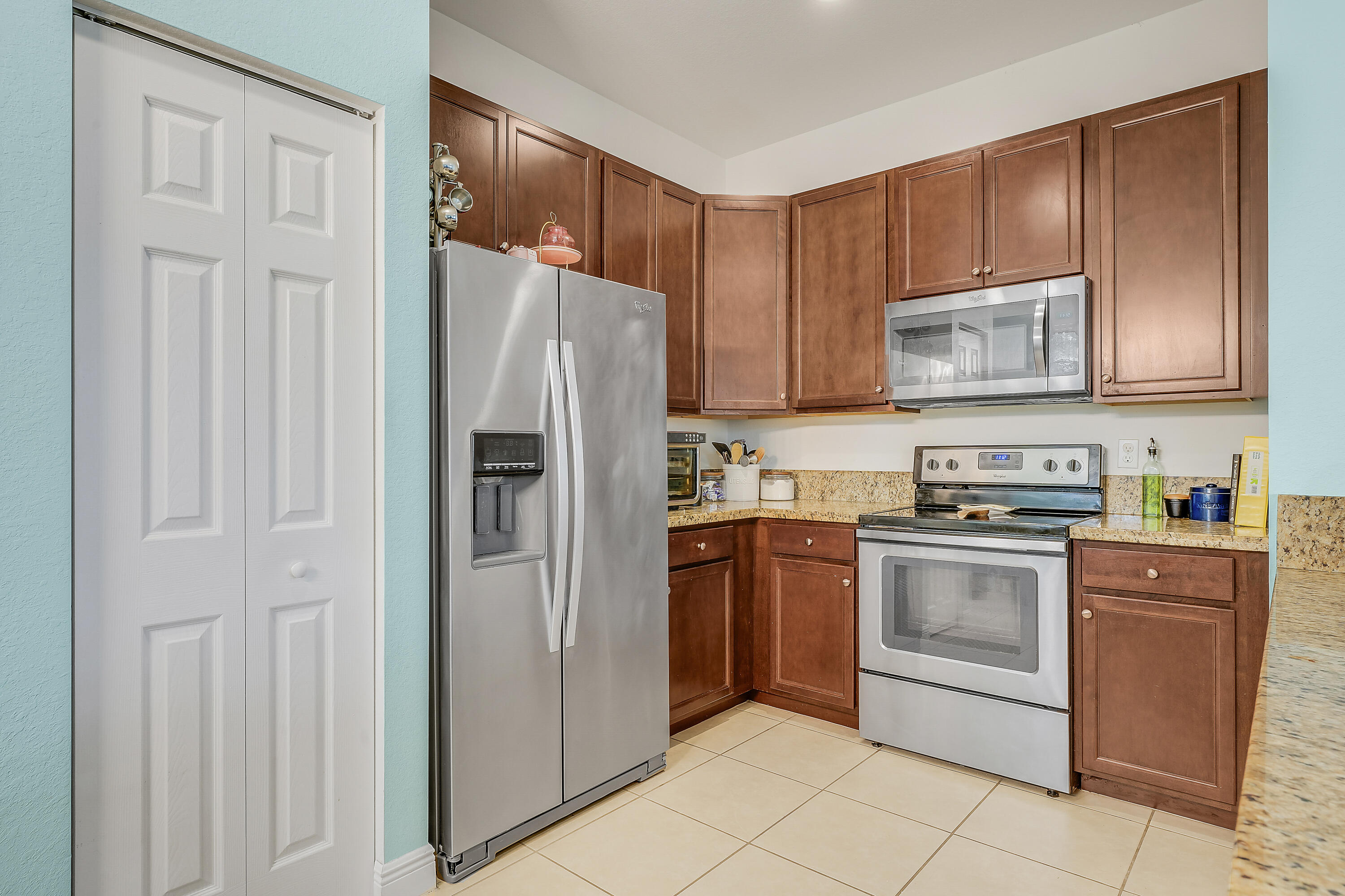 2900 Southwest 119th Way Miramar, FL 33025 - Photo 26 of 37 a kitchen with stainless steel appliances granite countertop a refrigerator stove and cabinets