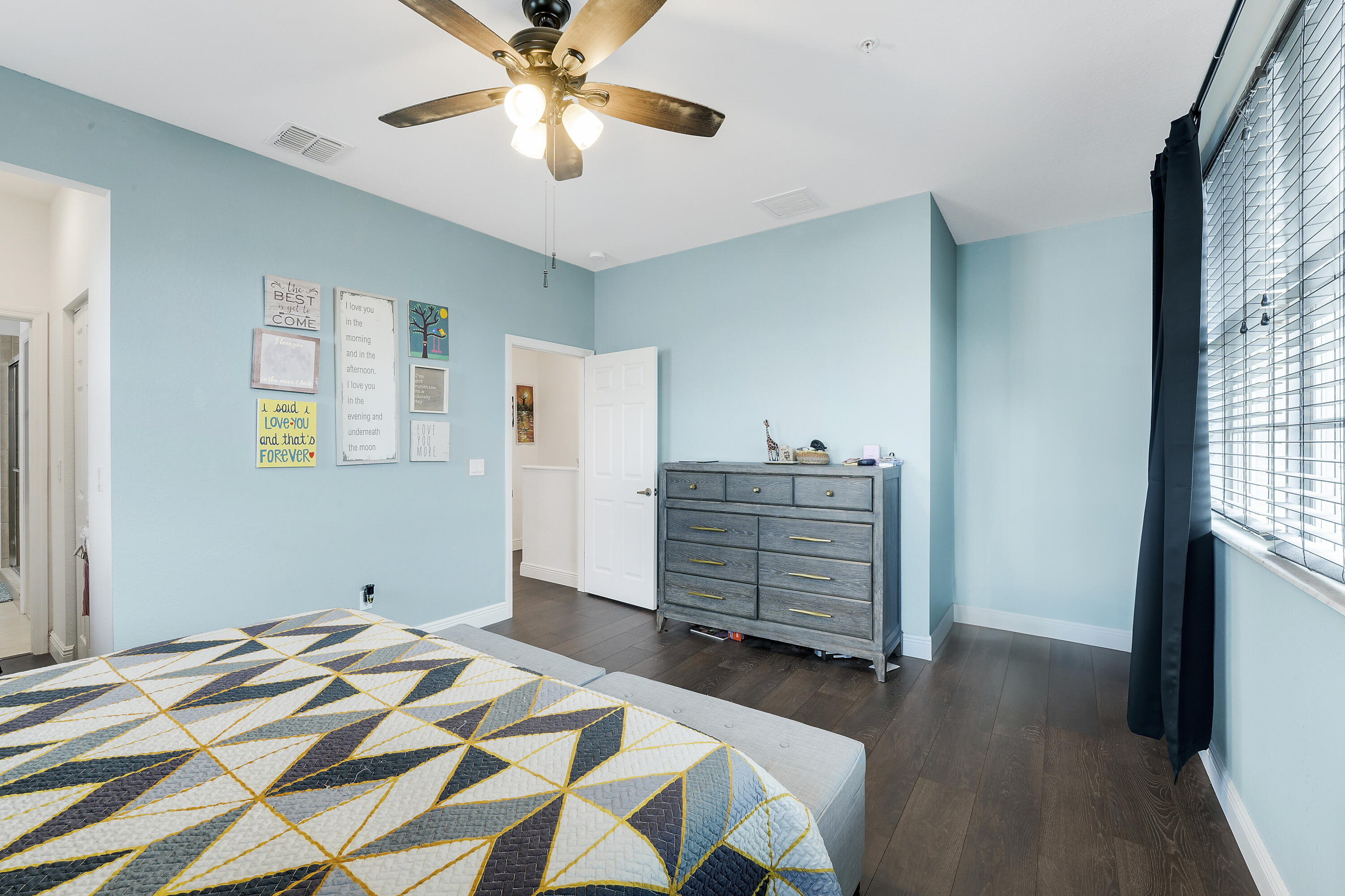 2900 Southwest 119th Way Miramar, FL 33025 - Photo 34 of 37 a bedroom with a bed and wooden floor