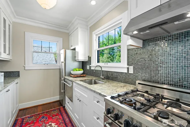 a kitchen that has a sink stove and window