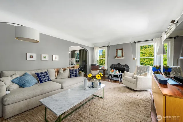 a living room with furniture and floor to ceiling windows