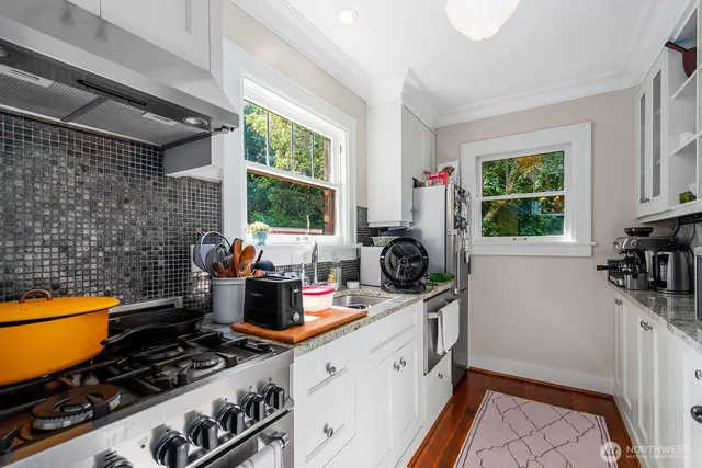 a kitchen with a stove and a window