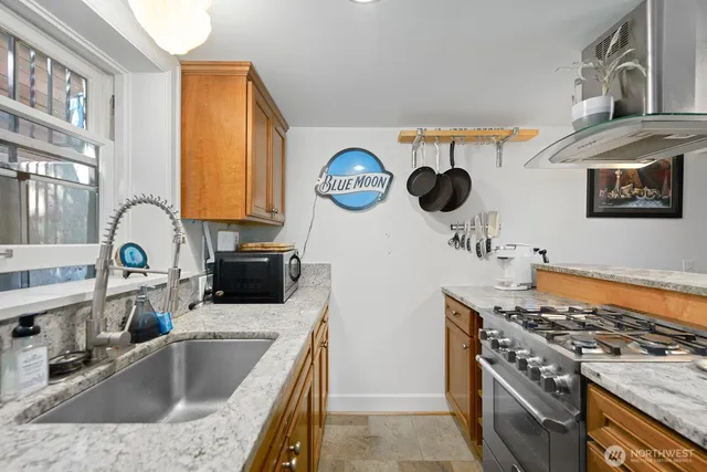 a kitchen with a sink and a stove top oven