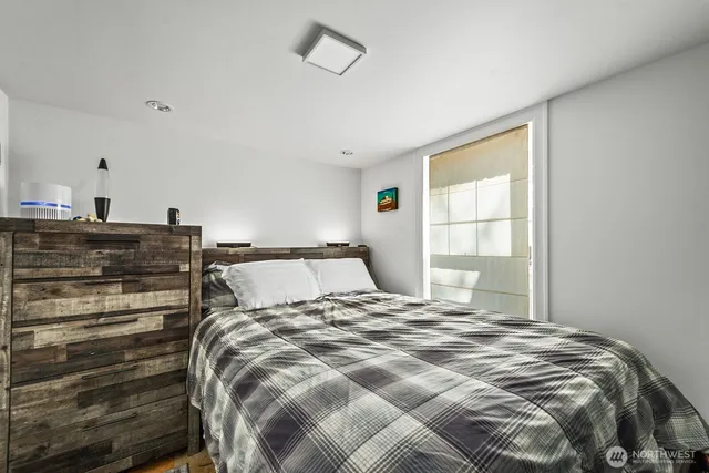 a bed sitting in a bedroom next to a window