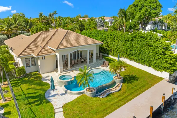 a view of house with swimming pool outdoor seating