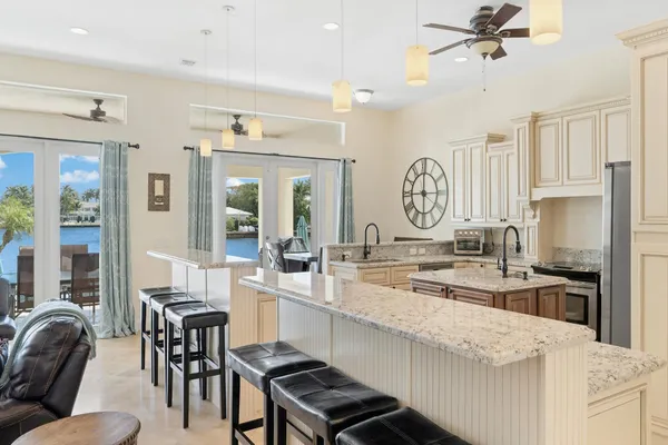 a large kitchen with kitchen island granite countertop a large dining table and chairs