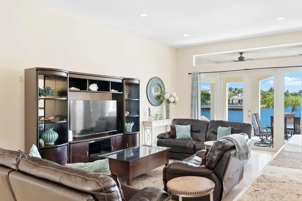 a living room with furniture a large window and a flat screen tv