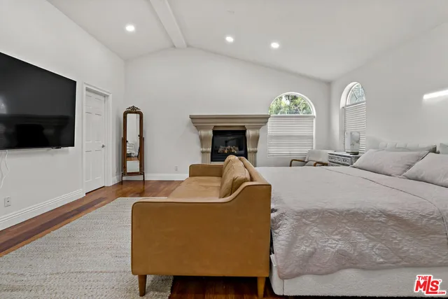 a spacious bedroom with a bed and a fireplace