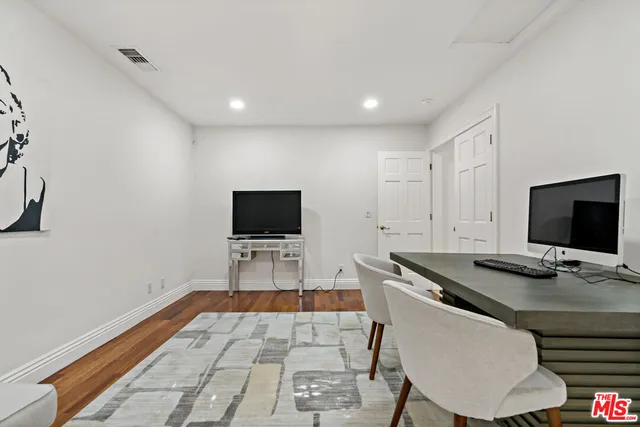 a bathroom with a granite countertop sink a mirror and a shower