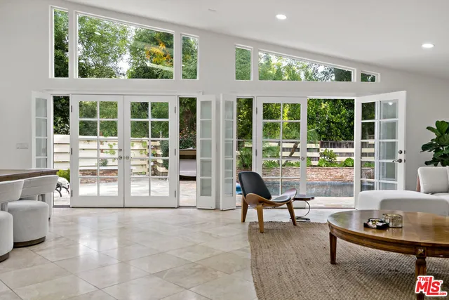 a kitchen with stainless steel appliances granite countertop a sink a stove and a refrigerator