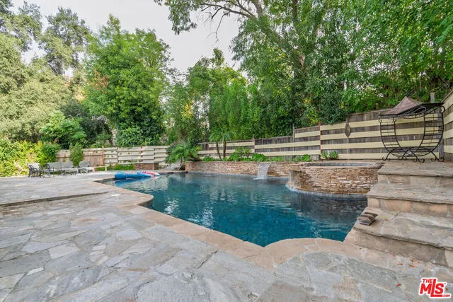 an aerial view of a house with a yard and potted plants