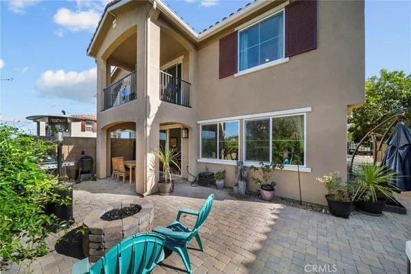 a view of an house with backyard and sitting area