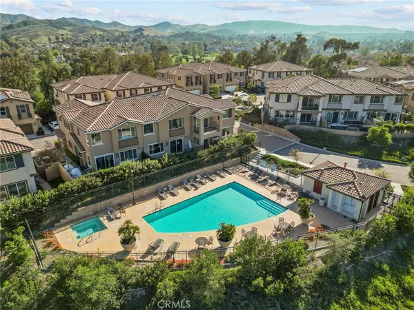an aerial view of a house with a swimming pool yard and outdoor seating