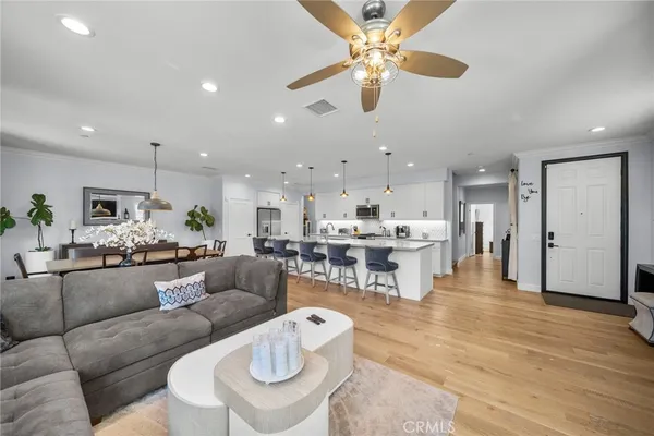 a living room with furniture and kitchen view