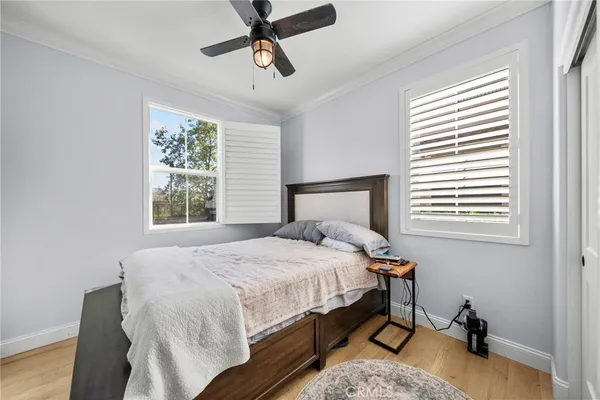 a bedroom with a bed a window and walk in closet