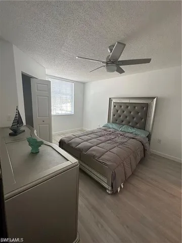 a bedroom with a bed and a ceiling fan