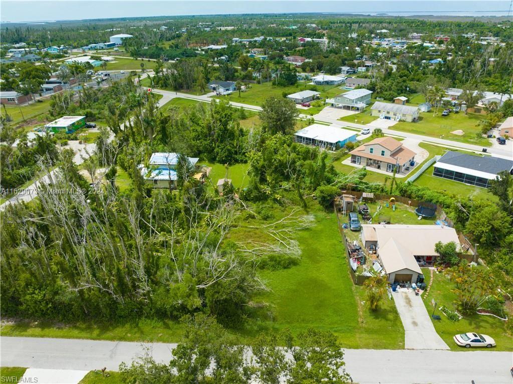 5409 Phillips Street Bokeelia, FL 33922 - Photo 2 of 7 an aerial view of residential houses with outdoor space and trees
