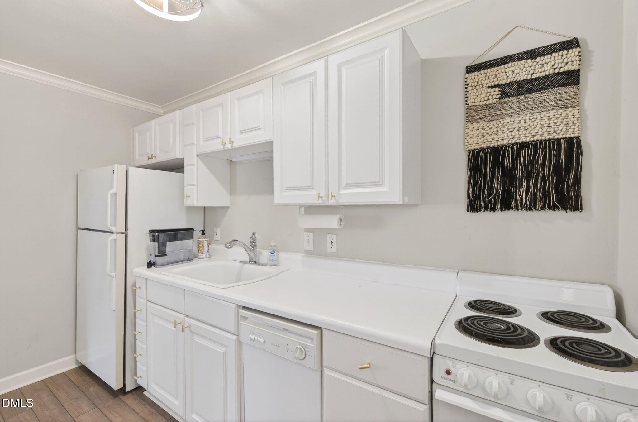 827 Daniels Street, Unit D Raleigh, NC 27605 - Photo 11 of 15 a kitchen with a sink cabinets and appliances
