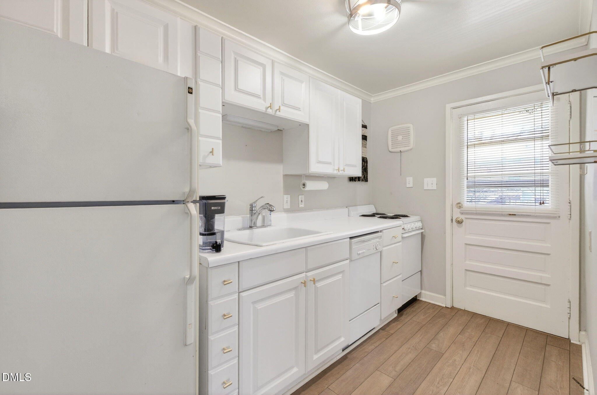 827 Daniels Street, Unit D Raleigh, NC 27605 - Photo 12 of 15 a bathroom with a sink a mirror and a shower