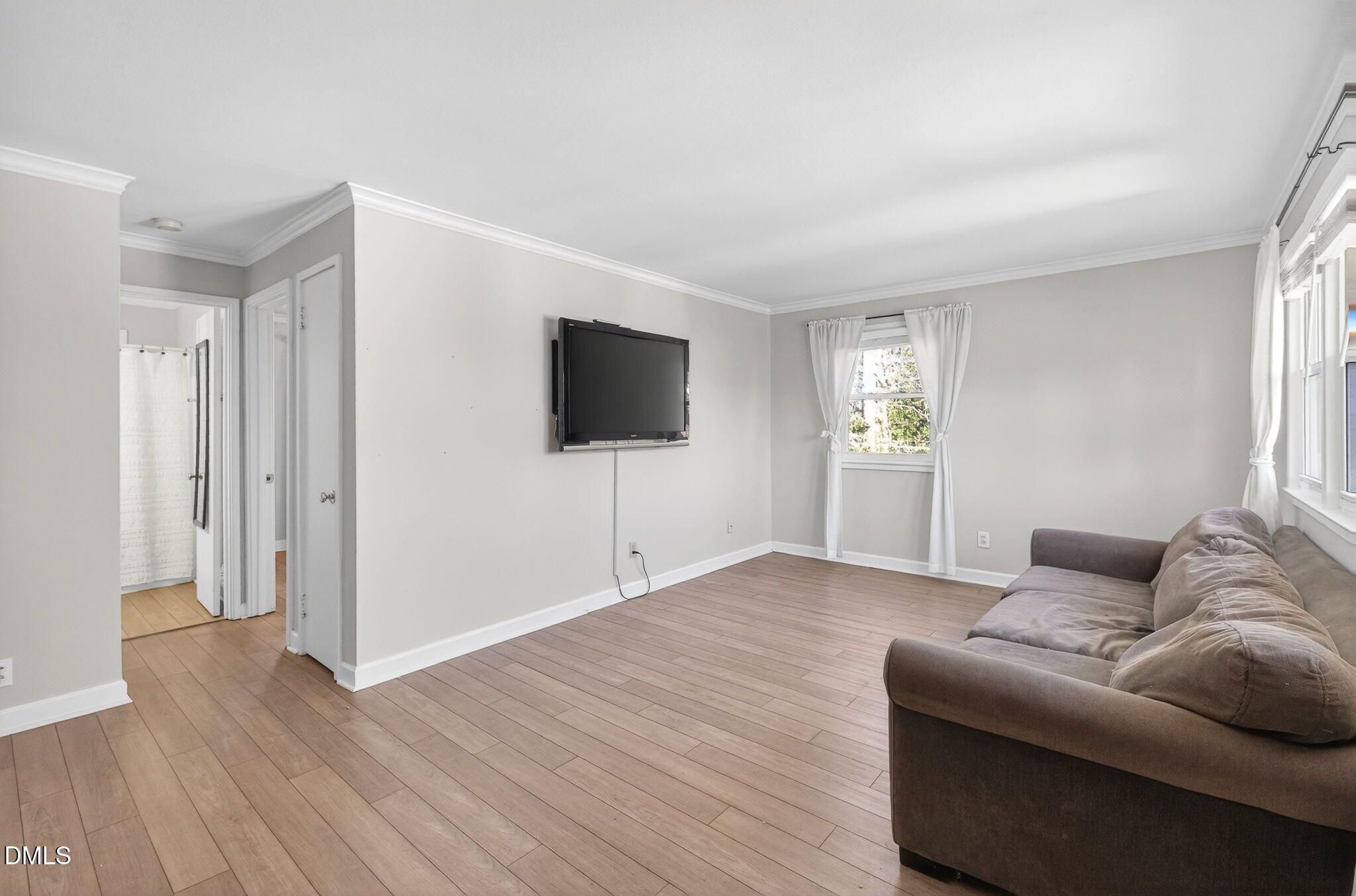 827 Daniels Street, Unit D Raleigh, NC 27605 - Photo 4 of 15 a living room with furniture and a flat screen tv