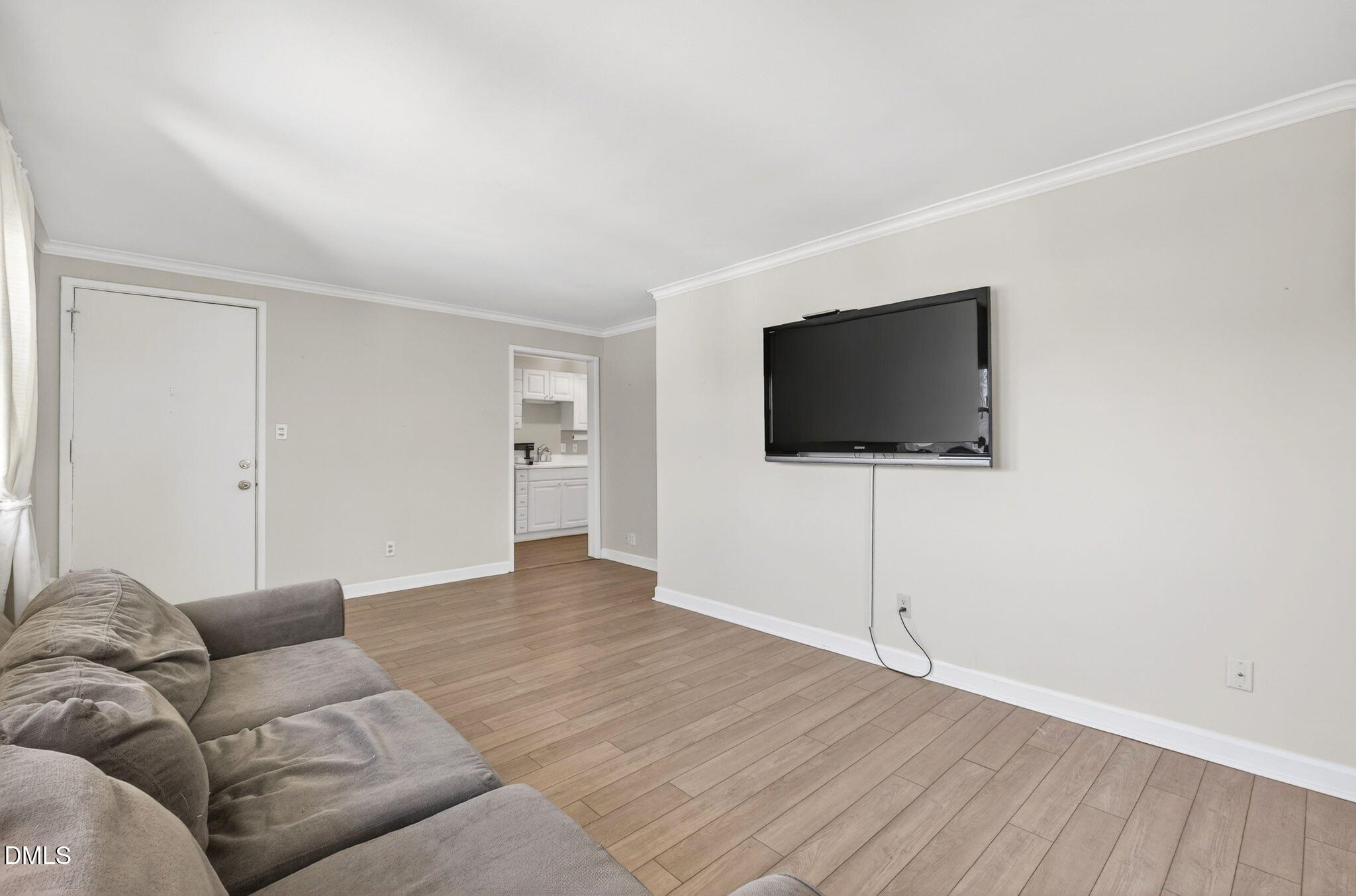 827 Daniels Street, Unit D Raleigh, NC 27605 - Photo 5 of 15 a living room with furniture and a flat screen tv