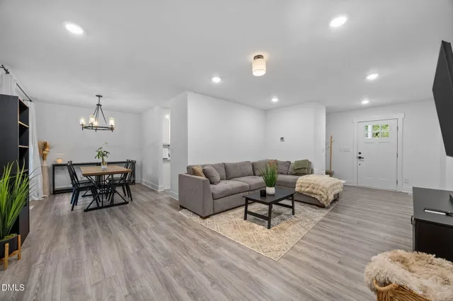 a living room with furniture and a wooden floor