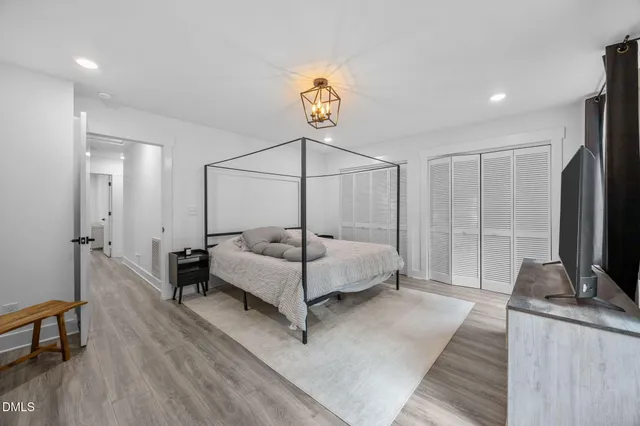 a bedroom with a bed and a flat screen tv