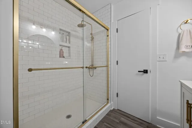a bathroom with a glass shower door