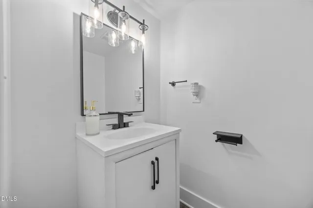 a bathroom with a sink a mirror and a vanity