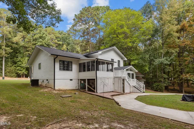 a view of a white house with a yard