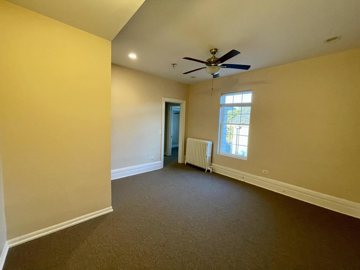 72 North 4th Street, Unit 4 Aurora, IL 60505 - Photo 6 of 11 a view of a livingroom with a ceiling fan and window