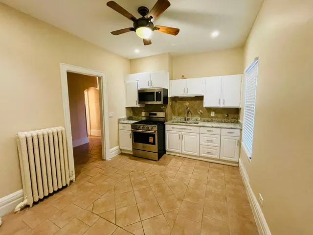 a kitchen with cabinets a sink and appliances