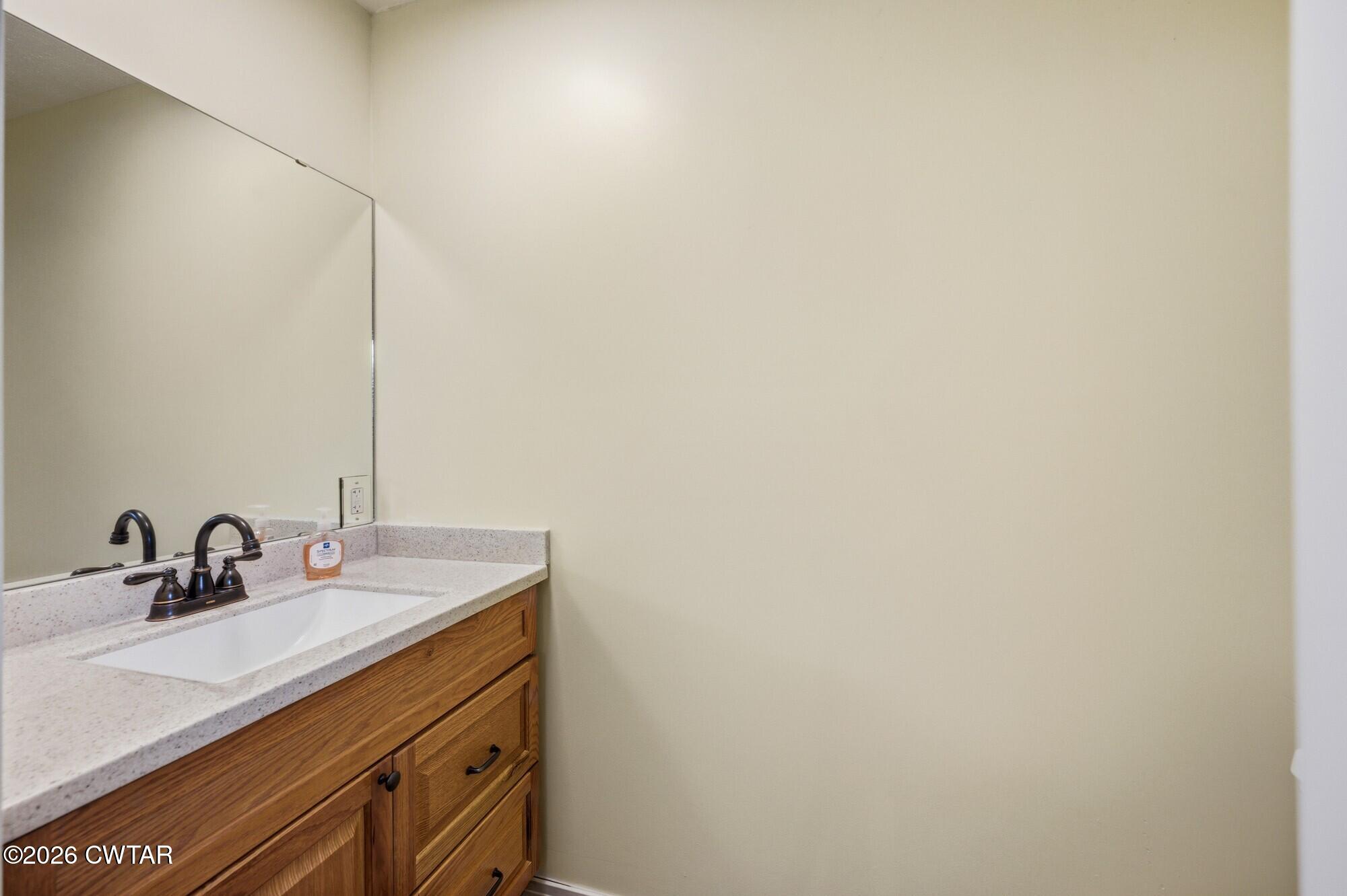 944 Brooksie Thompson Road Decaturville, TN 38329 - Photo 15 of 47 a bathroom with a sink and a mirror