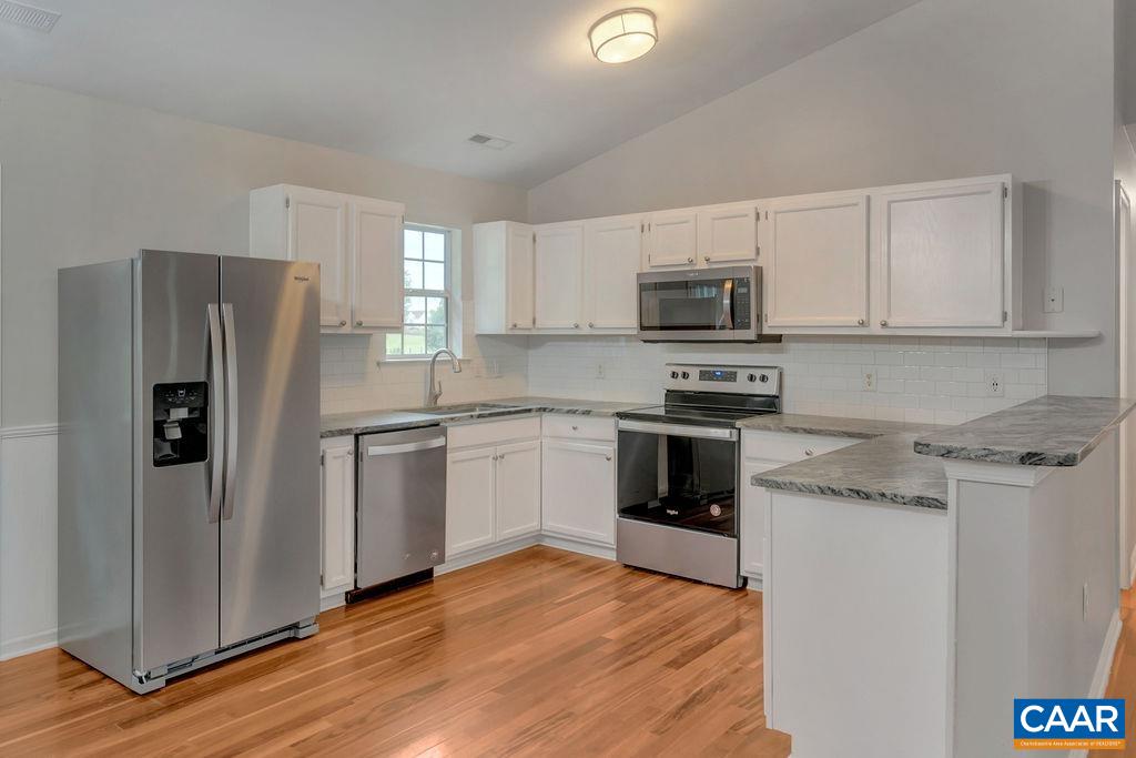 6807 Spring Hill Road Ruckersville, VA 22968 - Photo 18 of 37 a kitchen with stainless steel appliances granite countertop a refrigerator stove and microwave