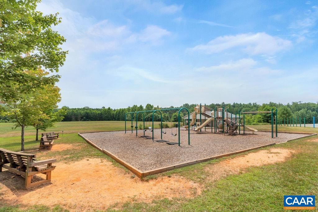 6807 Spring Hill Road Ruckersville, VA 22968 - Photo 36 of 37 a view of a swimming pool with a bench and trees in the background
