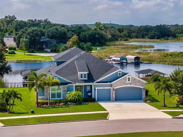 a aerial view of a house with swimming pool and lake view