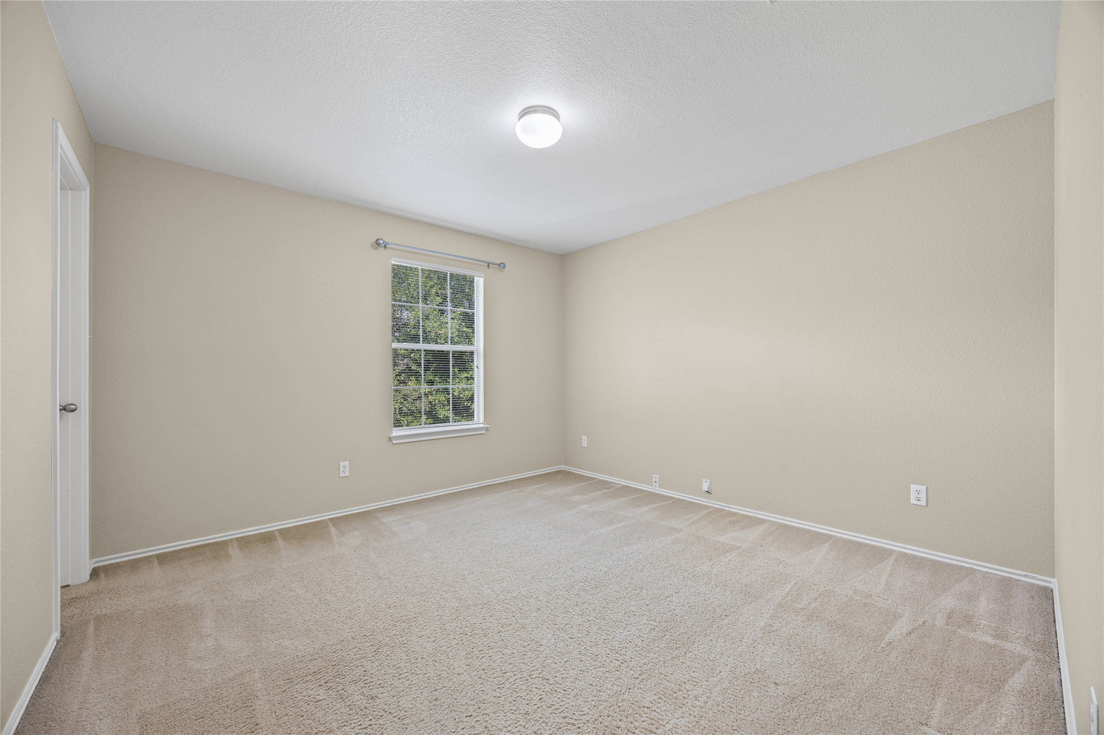 198 Black Forest Road Buda, TX 78610 - Photo 15 of 23 A well-lit bedroom with fresh, neutral walls and soft carpeting invites tranquil living.