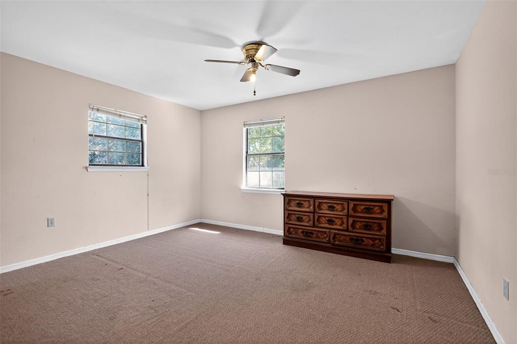 1925 Northwest 60th Avenue Ocala, FL 34482 - Photo 11 of 29 an empty room with windows and ceiling fan