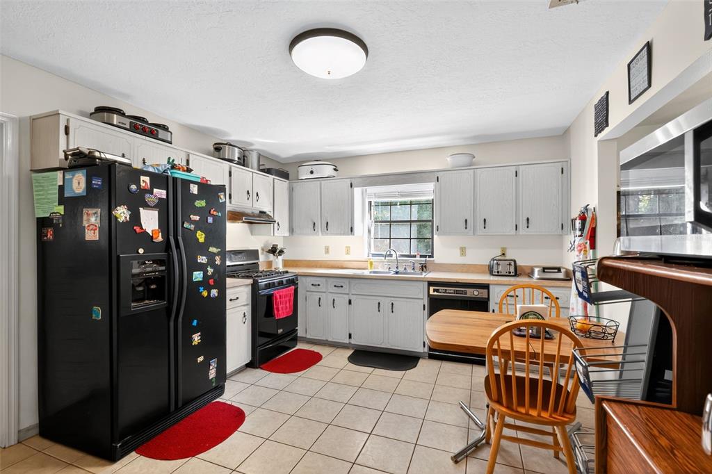 1925 Northwest 60th Avenue Ocala, FL 34482 - Photo 18 of 29 a kitchen with a refrigerator and a stove top oven