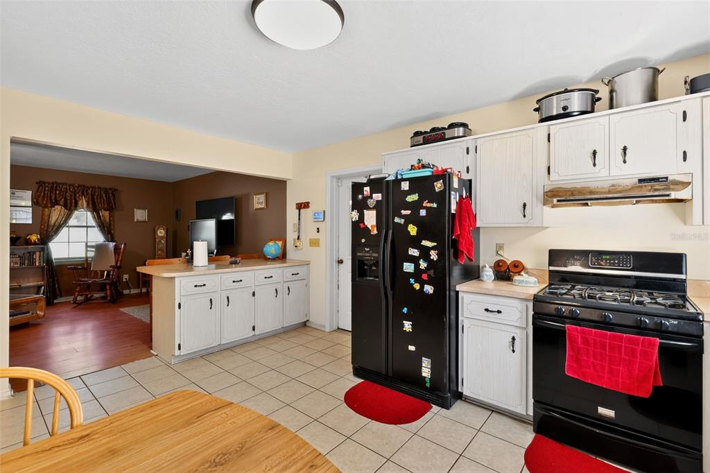 1925 Northwest 60th Avenue Ocala, FL 34482 - Photo 19 of 29 a kitchen with stainless steel appliances kitchen island granite countertop a stove a refrigerator and a dishwasher