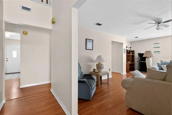 a living room with furniture and wooden floor