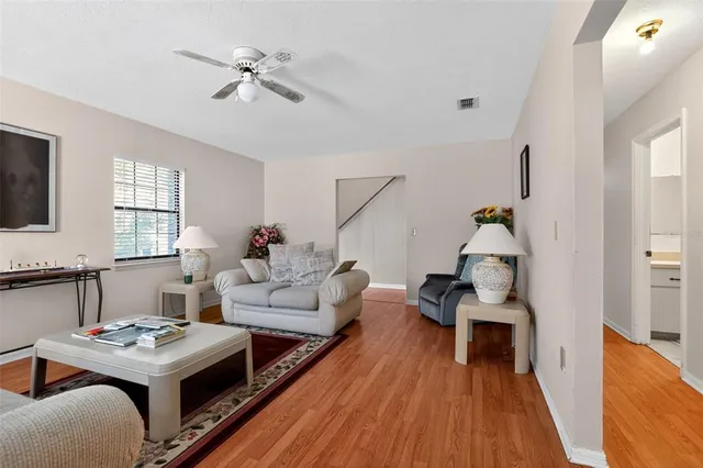 a living room with furniture and a wooden floor