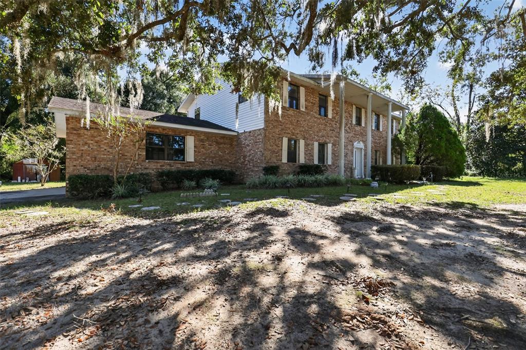 1925 Northwest 60th Avenue Ocala, FL 34482 - Photo 27 of 29 a front view of a house with a yard and trees