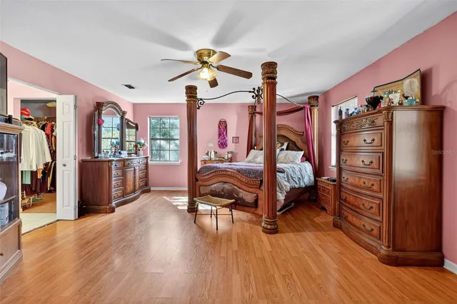 a bedroom with furniture and wooden floor