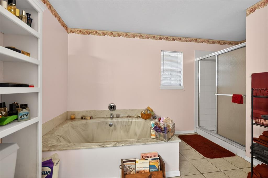1925 Northwest 60th Avenue Ocala, FL 34482 - Photo 5 of 29 a bathroom with a tub and shower curtain