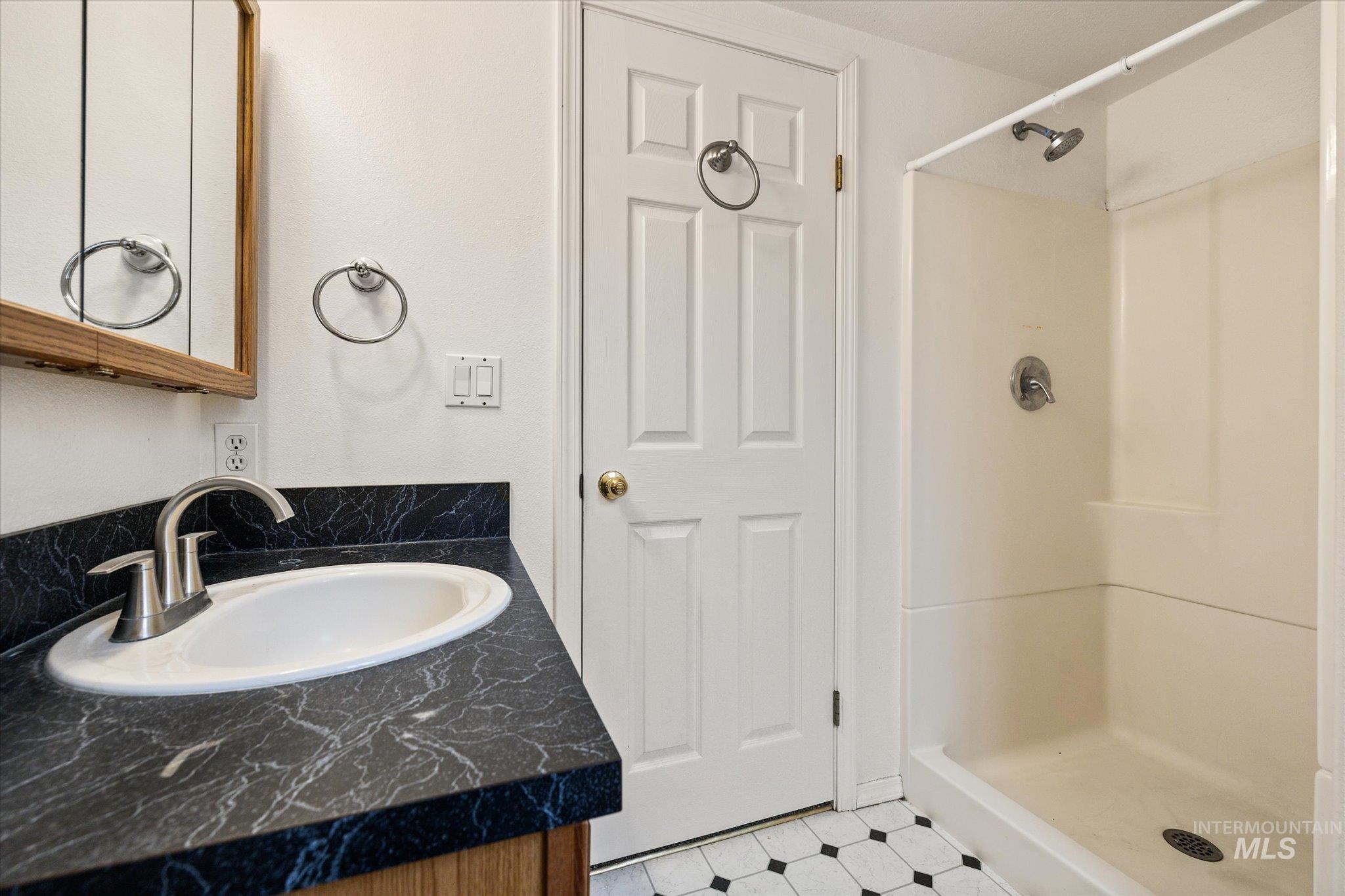 2870 North Morello Avenue Meridian, ID 83646 - Photo 12 of 20 Bathroom featuring a shower stall, vanity, and light flooring
