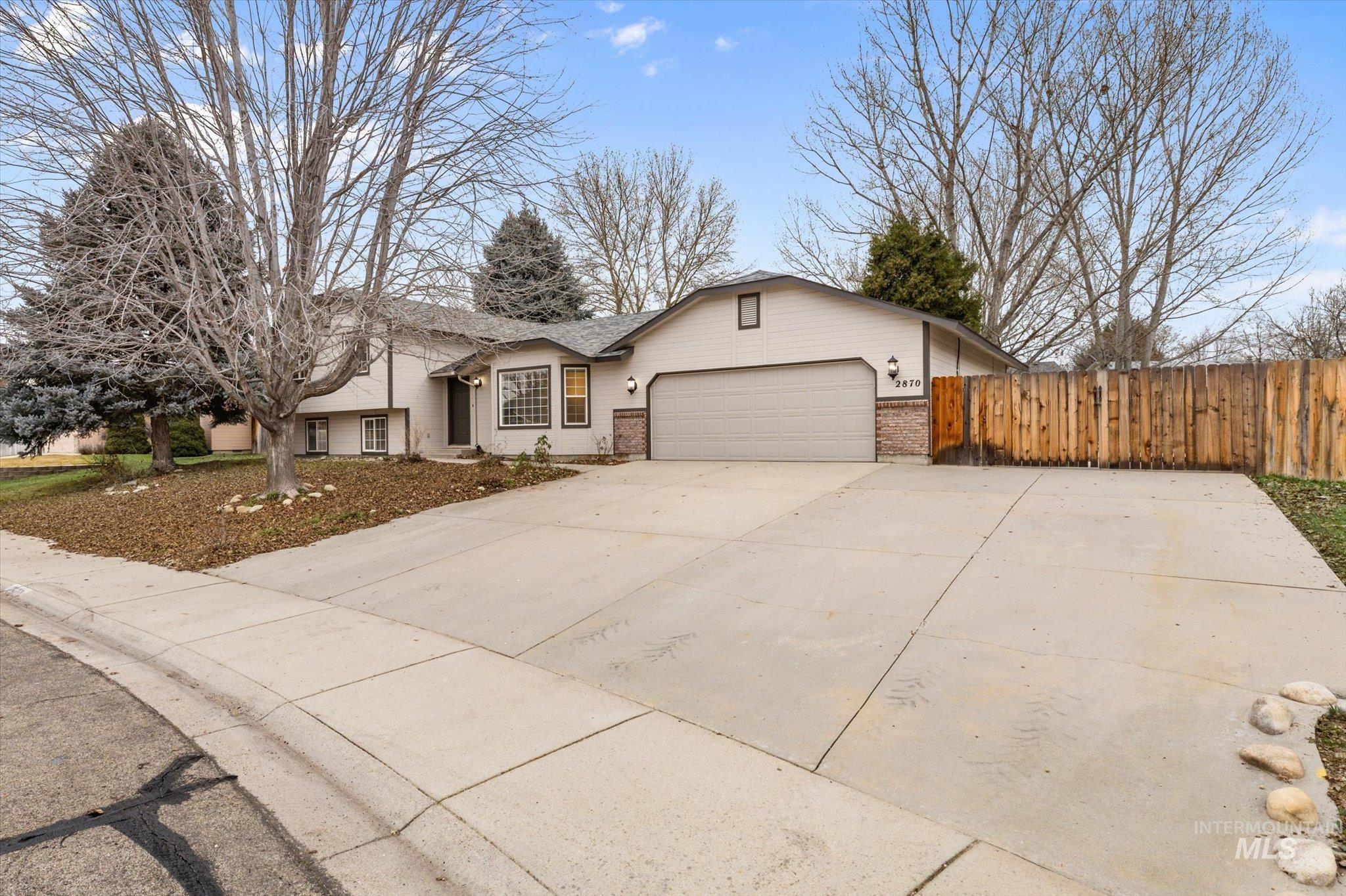 2870 North Morello Avenue Meridian, ID 83646 - Photo 18 of 20 View of front of home with brick siding, driveway, a garage, and a gate