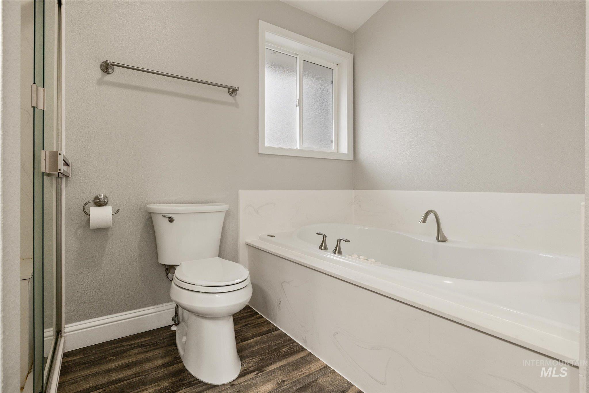 2870 North Morello Avenue Meridian, ID 83646 - Photo 6 of 20 Full bathroom featuring dark wood-style floors and a bath