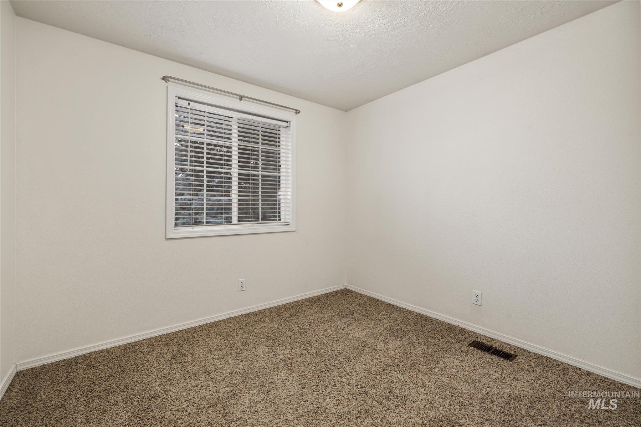 2870 North Morello Avenue Meridian, ID 83646 - Photo 7 of 20 Carpeted spare room featuring baseboards