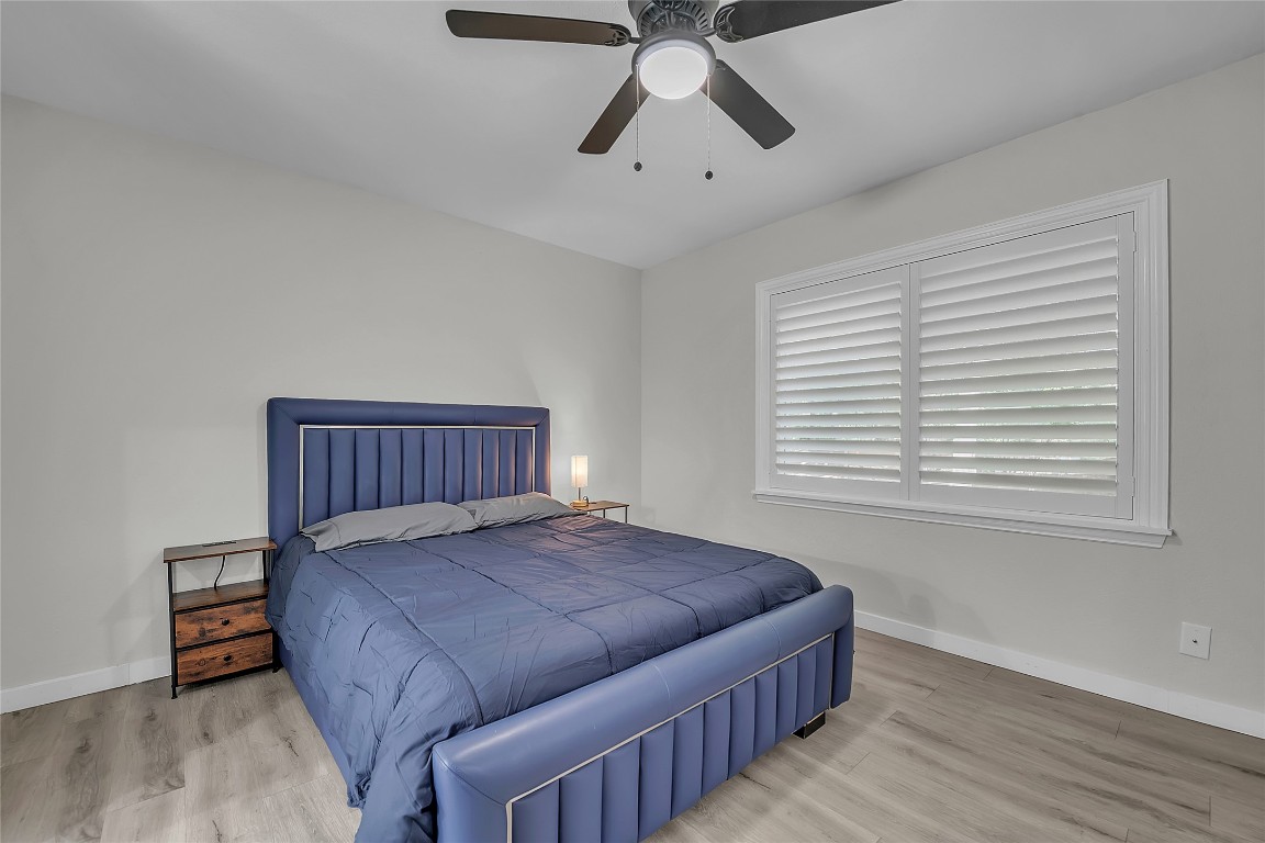 3400 Laguna Drive Austin, TX 78741 - Photo 12 of 24 a bedroom with a bed and wooden floor